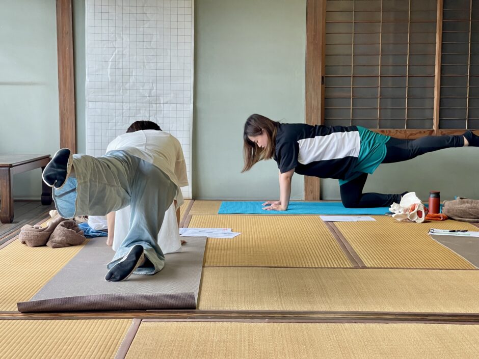 骨盤ケアのために腹筋・背筋とお尻の筋肉を連動して使うための四つ這いエクササイズを指導している場面です。