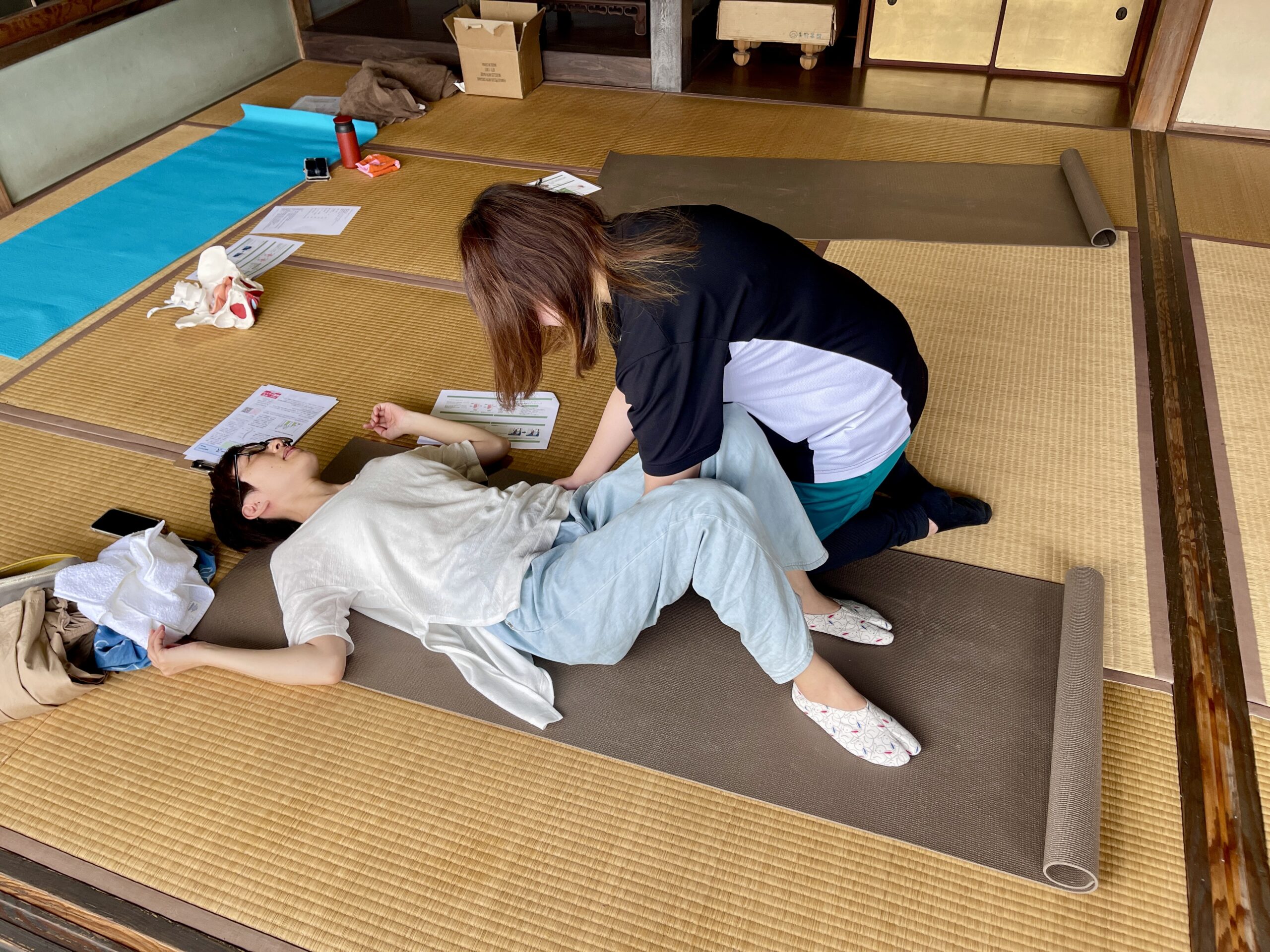 骨盤ケアのための体幹の筋肉の使い方について直接指導している場面です。